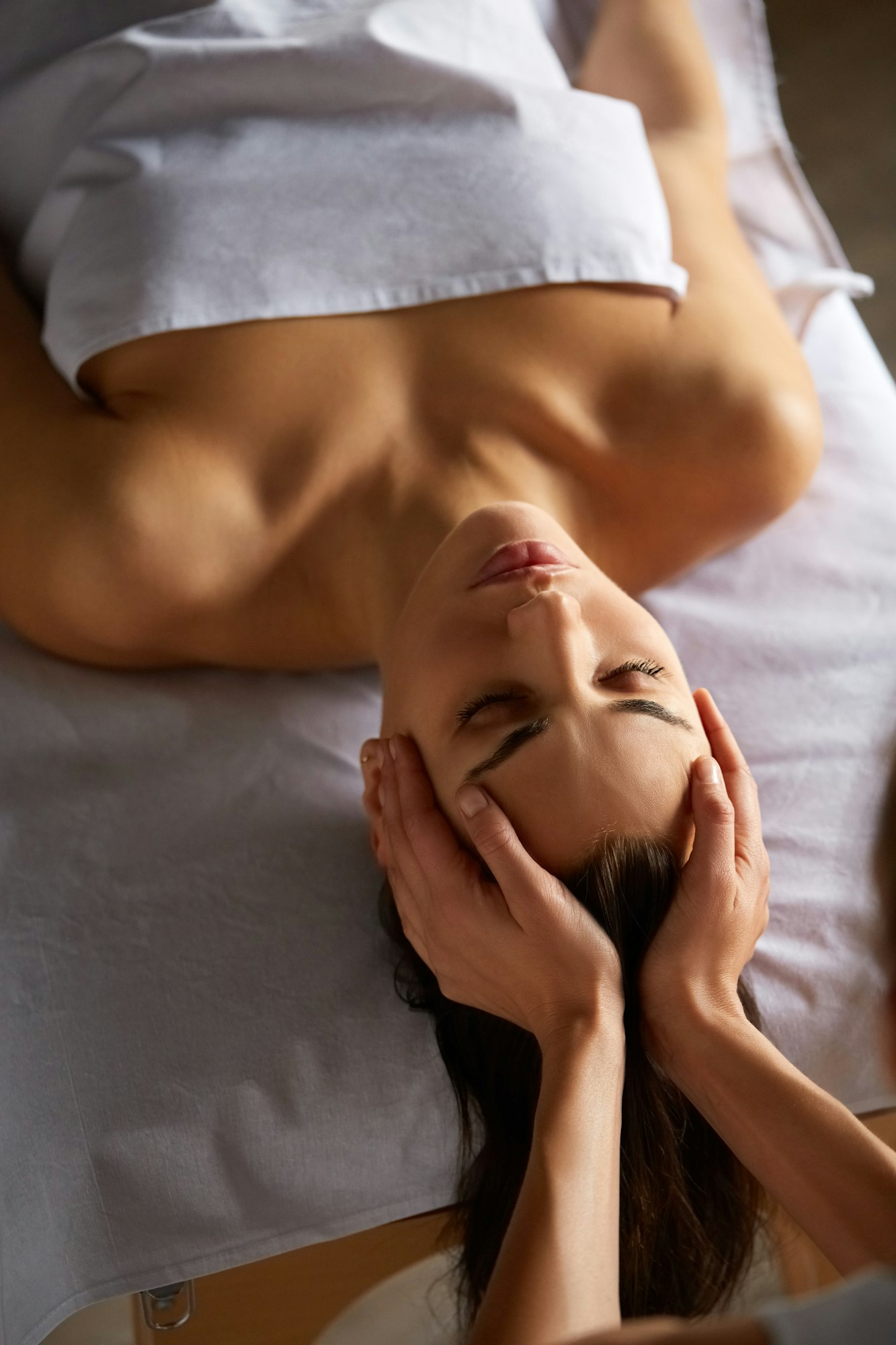 Head and face massage in spa salon